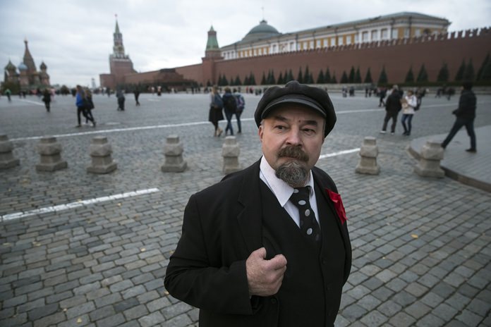 Lenin impersonator Sergei Soloviev waits for tourists in Red Square, Moscow, Russia. (AP Photo/Pavel Golovkin)