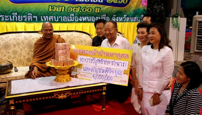 Famed AIDS activist and monk Alongkot Dikkapanyo (left) led alms-giving ceremonies to raise funds for the relocation of an AIDS hospice evicted from its Pattaya neighborhood by intolerant neighbors.