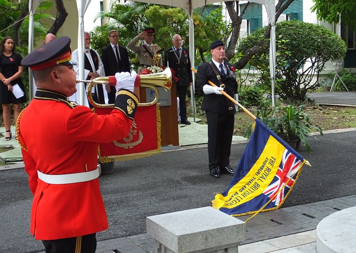 Richard Holmes, the RBL Thailand Standard Bearer, lowering the Legion Standard during the Last Post.