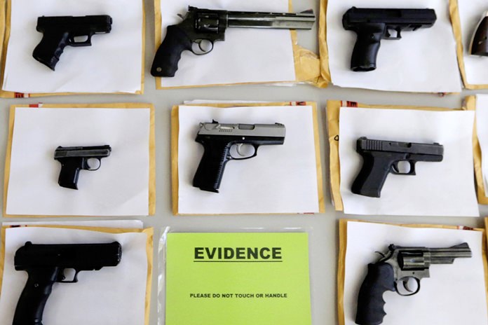 In this July 7, 2014 file photo, Chicago police display some of the thousands of illegal firearms confiscated during the year. In a government report released on Friday, Nov. 3, 2017, the U.S. rate for gun deaths has increased for the second straight year, following 15 years of no real change. (AP Photo/M. Spencer Green, File)