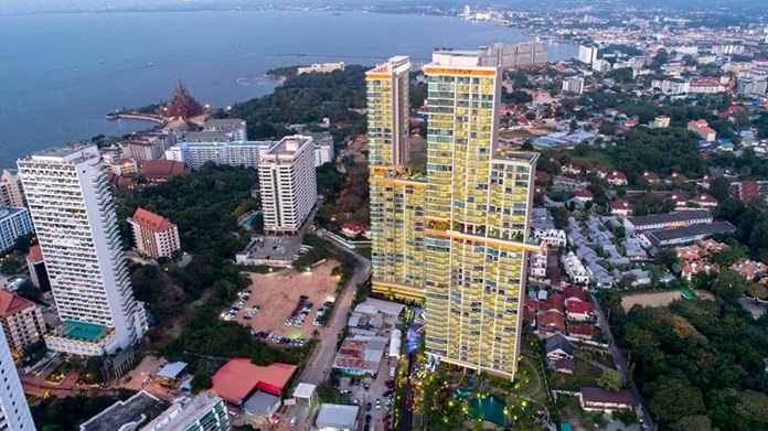 An aerial photo of the two tall towers glistening like jewels overlooking Pattaya bay.