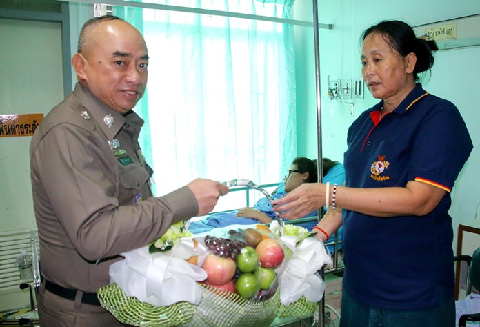 Pol. Lt. Gen. Jitti Rodbangyang brings a fruit basket to Netthip Phusuwan.