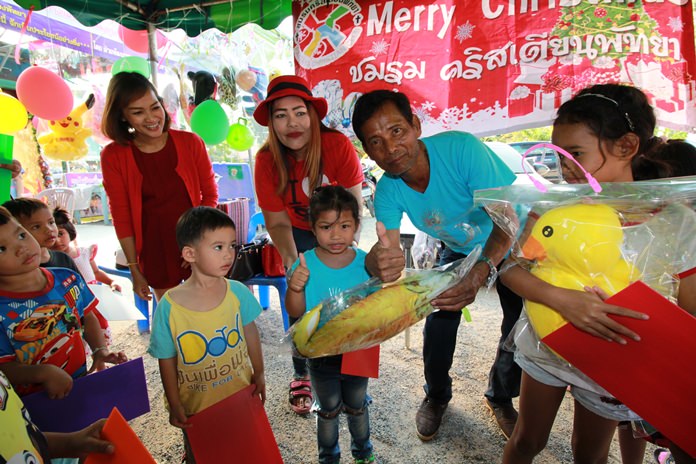 Soi Korphai Community Chairman Wirat Joyjinda and residents hand out Christmas gifts to grateful youngsters.