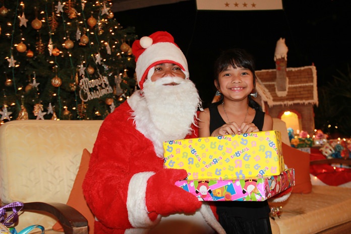 Bright eyes on this good little girl give away how delighted she is to receive a present from Santa at the Thai Garden Resort Pattaya.