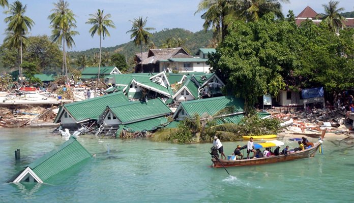 In this December 28, 2004 file photo, a boat passes by a damaged hotel at Ton Sai Bay on Phi Phi Island, southern Thailand, after it was hit by a tsunami. (AP Photo)