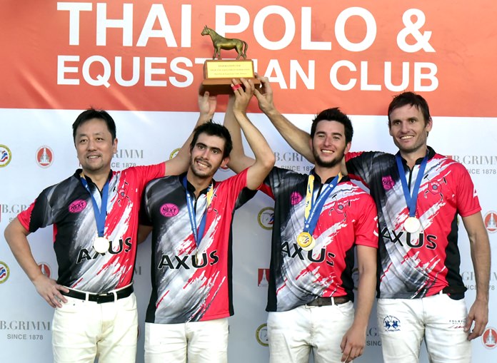 Axus team members celebrate on the podium after winning the Thai Equestrian Federation Cup at the Thai Polo & Equestrian Club in Pattaya, December 31.
