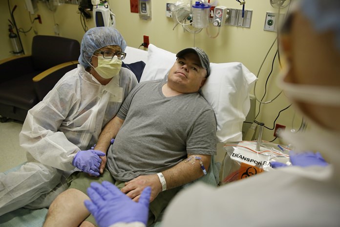 FILE - In this Monday, Nov. 6, 2017 file photo, Brian Madeux sits with his girlfriend Marcie Humphrey while waiting to receive the first human gene editing therapy at the UCSF Benioff Children’s Hospital in Oakland, Calif. Madeux, who has Hunter syndrome, received the treatment on Monday, Nov. 13. (AP Photo/Eric Risberg)