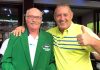 Phil Davies (right) presents a green jacket to John Anderson.