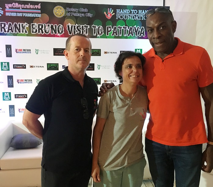 At the press conference, Frank Bruno meets Margie from Hand to Hand and Derek from the Father Ray Foundation.