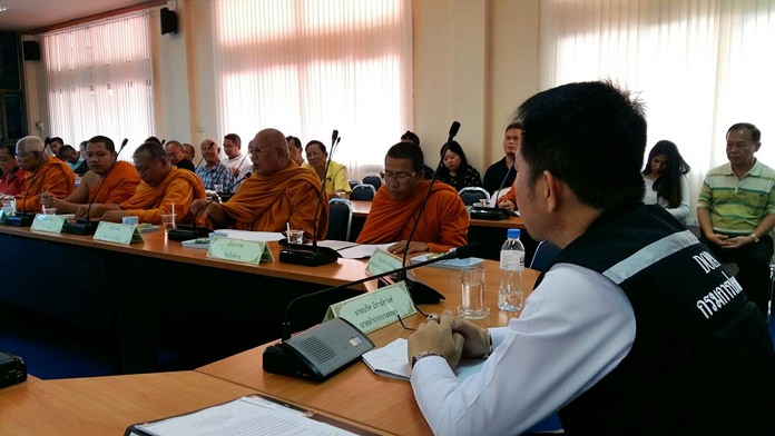 District Chief Naris Niramaiwong (right) addresses police, military, Revenue Office and Office of Buddhism officials about launching random inspections of Pattaya-area temples following complaints about price gouging for amulets.