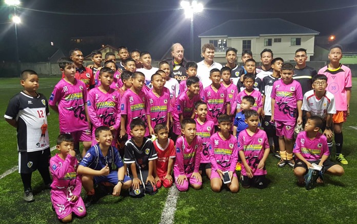 Coach ‘Nui’ Chaloemwut Sa-gnapol (standing 6th right, rear) poses with the young soccer students at the Palladium football fields on Soi Korphai in Pattaya, January 17.