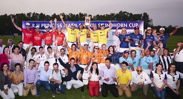 Royal Pahang of Malaysia (centre rear) hold the trophy as they pose with competing teams and supporters at the conclusion of the 2018 Carrier - B.Grimm Thai Polo Open, January 20 at the Thai Polo & Equestrian Club.