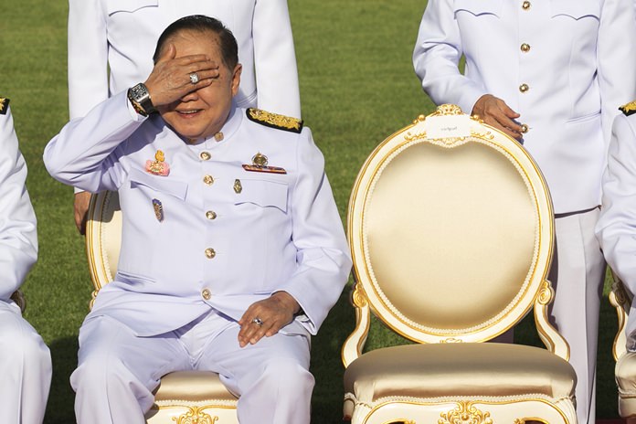 In this Dec. 4, 2017, photo, Deputy Prime Minister Prawit Wongsuwan raise his hand to shade the sun wearing a luxury watch and diamond ring during a ceremony at Government House in Bangkok. (AP Photo/Krit Phromsakla Na Sakolnakorn)