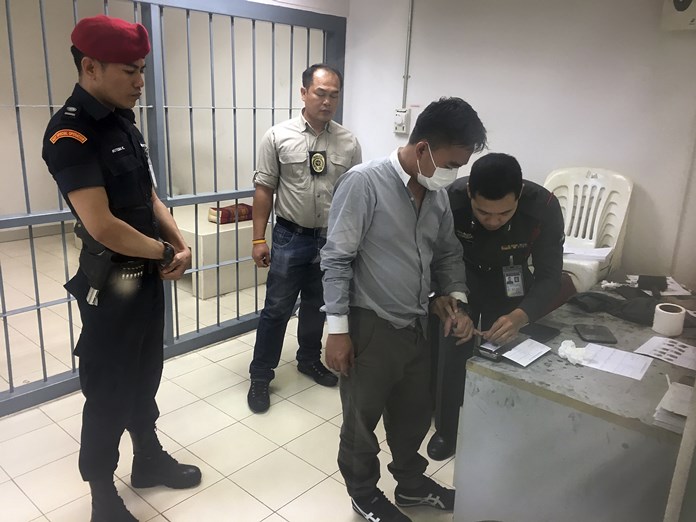 Police process suspected wildlife trafficker Boonchai Bach, a 40-year-old Thai of Vietnamese descent, Saturday, Jan. 20, in Bangkok. (AP Photo/Tassanee Vejpongsa)