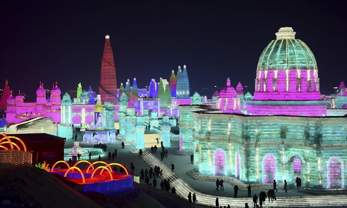 In this Jan. 2, 2018 photo, visitors walk among the attractions at the Harbin International Ice and Snow Festival in Harbin in northeastern China's Heilongjiang Province. (Chinatopix via AP)