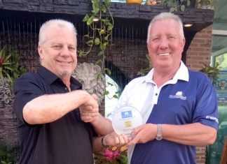 Sel Wegner (left) receives his medal from Brian Chapman.