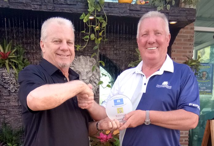 Sel Wegner (left) receives his medal from Brian Chapman.