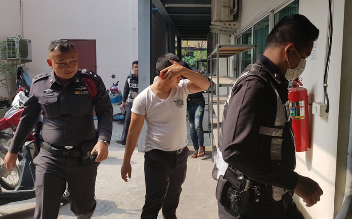 Nongprue Pol. Lance Cpl. Ratchanon Dannattee (center), along with Poldanai Dhammakul and Prasert Kongkhao (not shown), surrendered to Pattaya police to face accusations of kidnapping, rape and extortion.