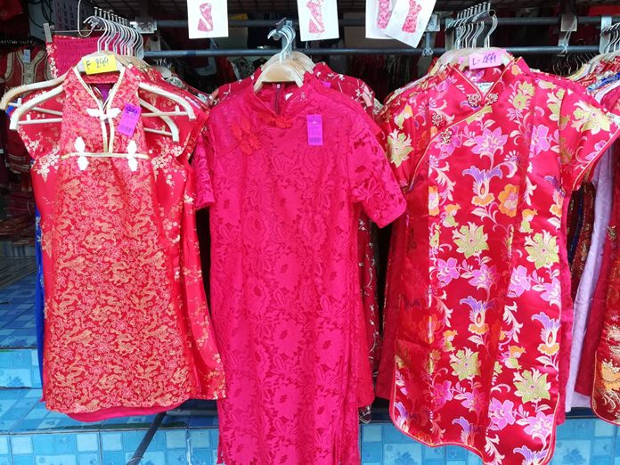 Naklua’s five big shops selling the body-hugging one piece qipao dresses were bustling for the “Year of the Dog” celebrations.