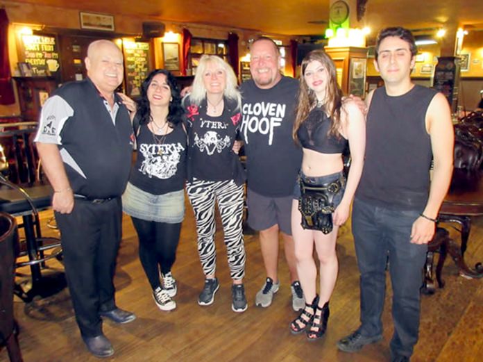 Landlord Kim Fletcher (left) welcomes members of rock band Syteria to Jameson’s Irish Pub in Pattaya.