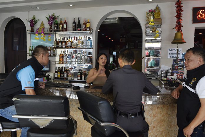 Chief investigator, Pol. Lt. Col. Teerasak Seesaeng, interviews Ladda Onphukhao, the cashier at Ruby Club, who was seated only a meter away from the brief, but brutal, fight.