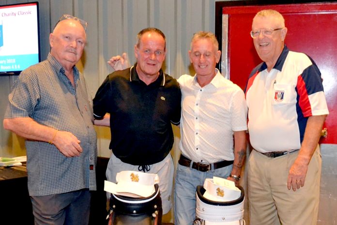 Tournament winners Thomas Ostle and Brian Morville (centre) receive their golf bag prizes.