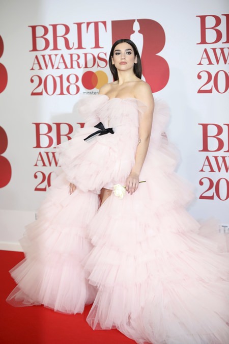Singer Dua Lipa poses for photographers upon arrival at the Brit Awards 2018 in London, Wednesday, Feb. 21. (Photo by Vianney Le Caer/Invision/AP)