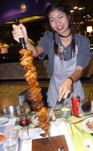 The happy lady with the skewers.