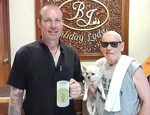 Bill from BJ’s Holiday Lodge (right) presents the monthly mug to Paul Weatherley.
