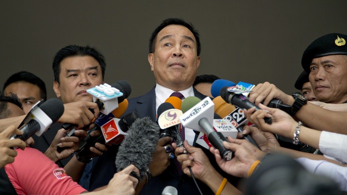 Former national police chief Somyot Poompanmoung, center, speaks after being interrogated at the Department of Special Investigation in Bangkok, Thursday, Feb. 15. (AP Photo/Gemunu Amarasinghe)