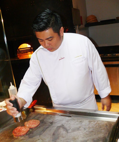 Chef Tofu preparing his burger.