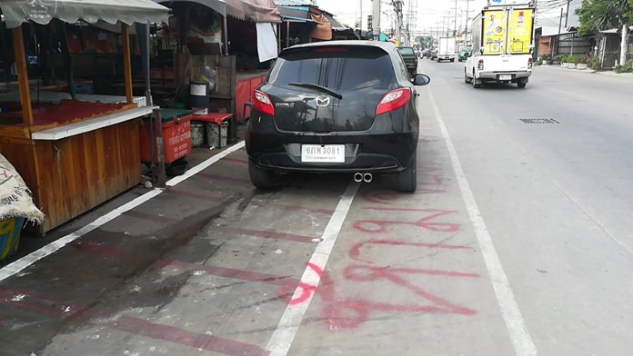 Nongprue road workers painted new lane lines as well as 45-degree parking spots to make street parking more efficient, and legal. Evidently the driver of this vehicle is above the regulations.