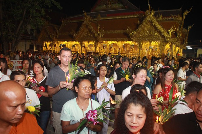 Thais and foreigners alike join to observe the religious holiday by joining in the Wien Tien activities at Wat Nong Or.