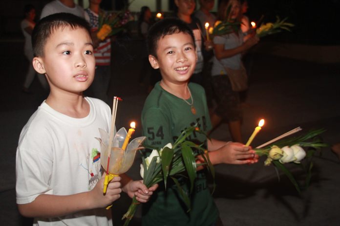 Young Thai boys enjoy themselves as they join the Wien Thien procession on Makha Bucha Day.