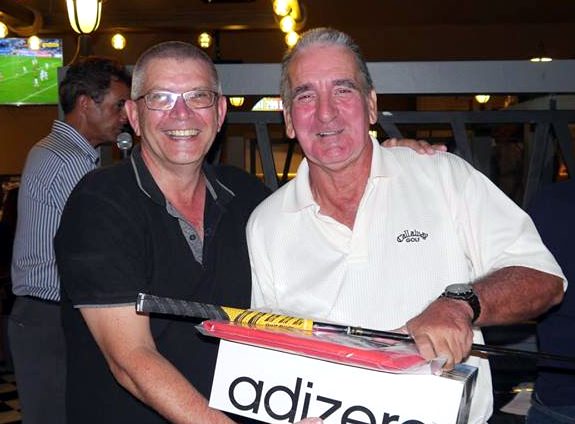 A Flight winner Myles Knowlson (right) receives his prize.