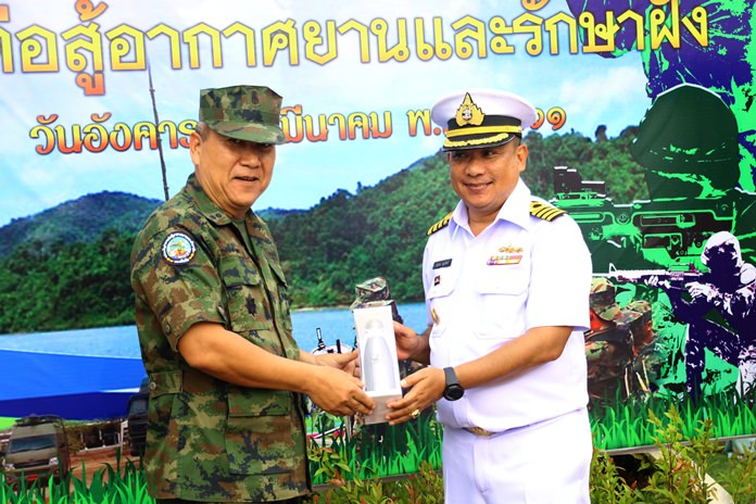 Air and Coastal Defense Command Chief Rear Adm. Wara Tankham presents a gift to air patrol commander, Capt. Marudech Boonnith in celebration of the 43rd anniversary of the Royal Thai Navy’s coastal air patrol unit.