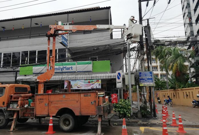 Provincial Electricity Authority workers replace power lines in South Pattaya that burst into flames due to a faulty connection.
