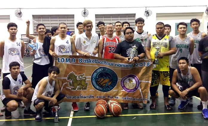 Winners and runners-up pose with their trophies at the conclusion of the Loma Basketball Tournament 2018 on March 12 at the Eastern National Indoor Sports Stadium in Pattaya.