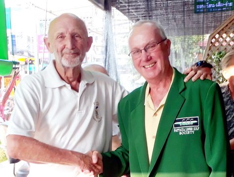 Len Jones (left) presents the green jacket to Dave Moriarity.