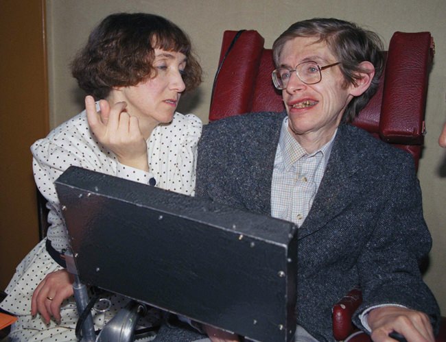 In this March 3, 1989 file photo British astrophysicist Dr. Stephen Hawking, 47, answers newsmen with the help of his computer and the assistance of his then wife Jane, in Paris. (AP Photo/Lionel Cironneau, File)