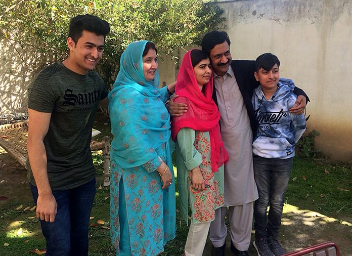 Pakistan’s Nobel Peace Prize winner Malala Yousafzai, center, poses for a photograph with her family members at her native home during a visit to Mingora, the main town of Pakistan Swat Valley, Saturday, March 31, 2018. Yousafzai arrived in her hometown for the first time since a Taliban militant shot her there in 2012 for advocating girls’ education. (AP Photo/Abdullah Sherin)