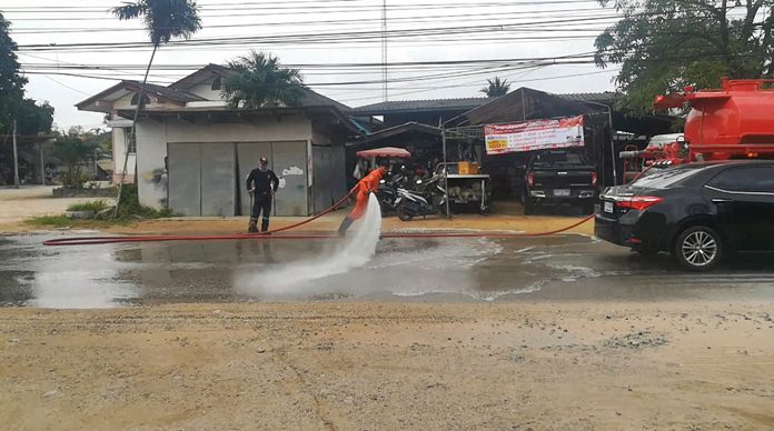 A 10-strong work crew took two water trucks to dusty Nongprue Road to hose it down and get rid of the sand.