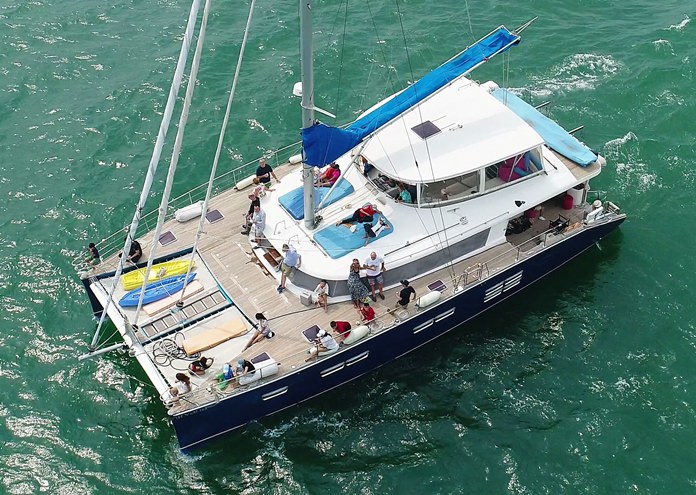 PCEC members enjoy a nice ocean breeze as they travel on a large catamaran arranged by Kevin Scott so they could observe Nina sailing in her small yacht.