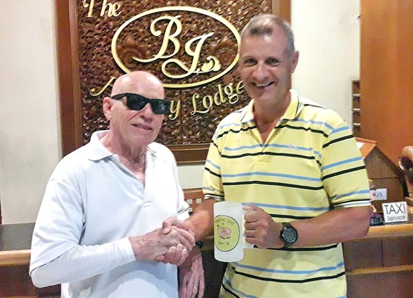 Richard Kubicky (right) being presented with the mug by BJ.