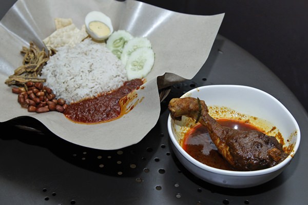 Malaysia’s national dish, Nasi Lemak and chicken rendang, are shown at a restaurant in Subang Jaya, Malaysia, Tuesday, April 3. (AP Photo/Sadiq Asyraf)