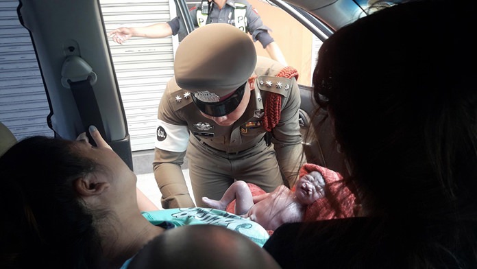 Pol. Capt. Chatchai Sripalang and Pol. Capt. Thepparod Kaseamsuk called on their training to deliver a healthy baby girl in the front seat of an Isuzu pickup truck on Sukhumvit Road.