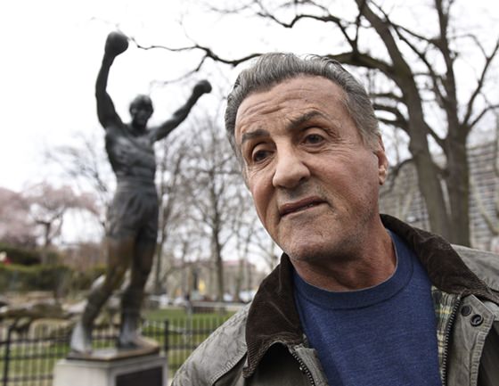Sylvester Stallone talks to reports in front of the Rocky statue for a “Creed II” photo op, Friday, April 6 in Philadelphia. The film, part of the “Rocky” film franchise, will be released later this year. (AP Photo/Michael Perez)