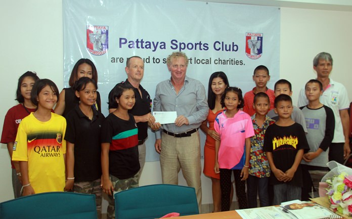 Fr. Ray Foundation representative Derek Franklin (center left), receives a benevolent donation from Pattaya Sports Club President Maurice Roberts and Social Welfare Chairwoman Noi Emerson.