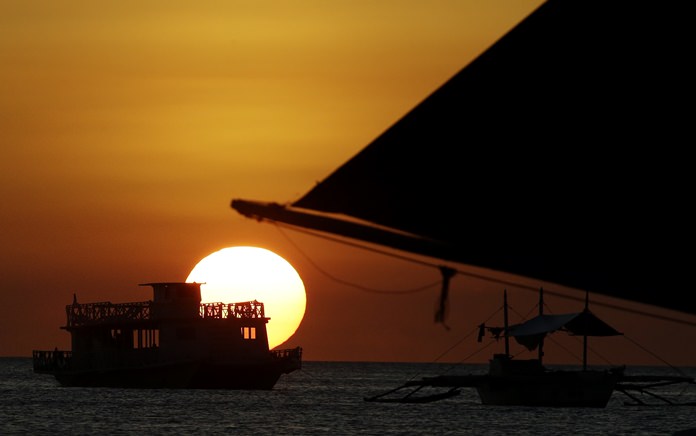 The sun sets at the country’s most famous beach resort island of Boracay, in central Aklan province, Philippines, Tuesday, April 24, 2018. (AP Photo/Aaron Favila)