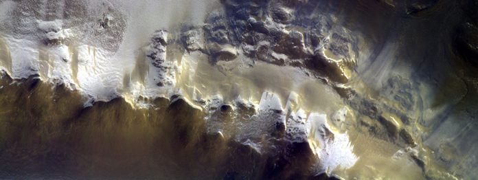 The European Space Agency has released its first image taken by a probe orbiting Mars, showing the ice-covered edge of a vast crater. (ESA/Roscosmos/CaSSIS via AP)